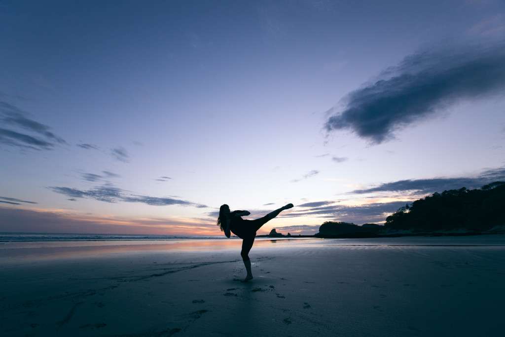 Silhouette or women on beach kicking