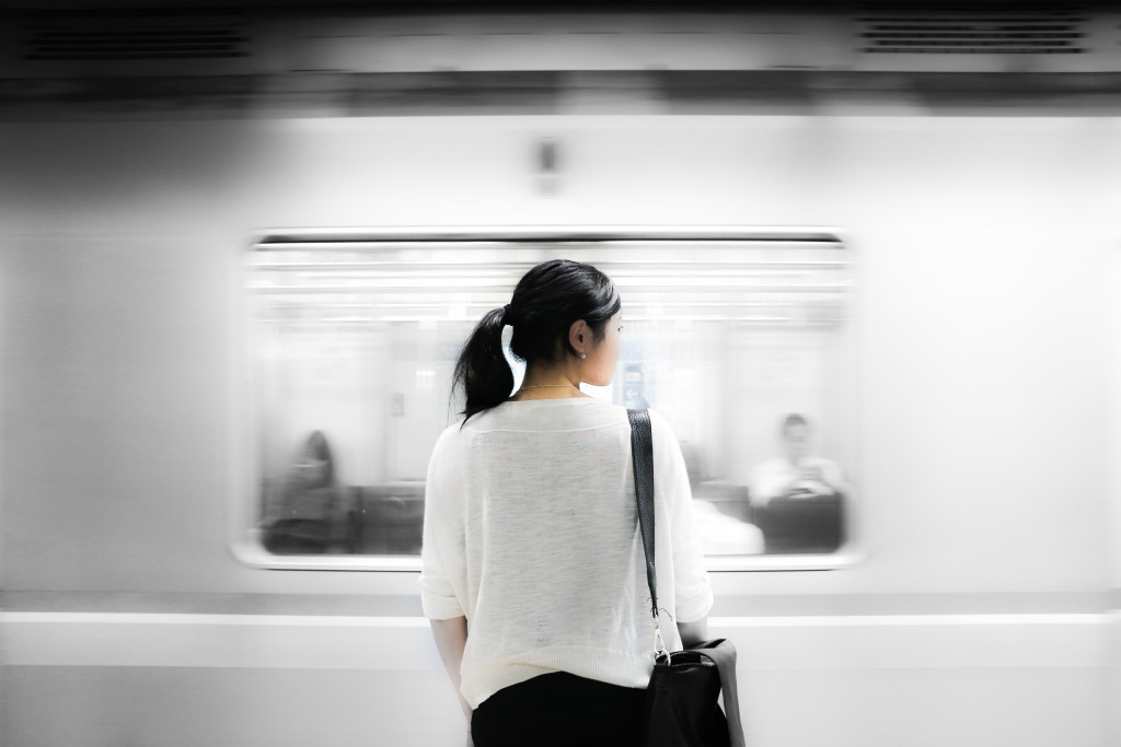 Women standing in front of moving train