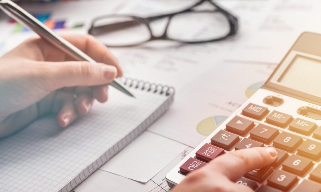 A person using a calculator for payroll accounts