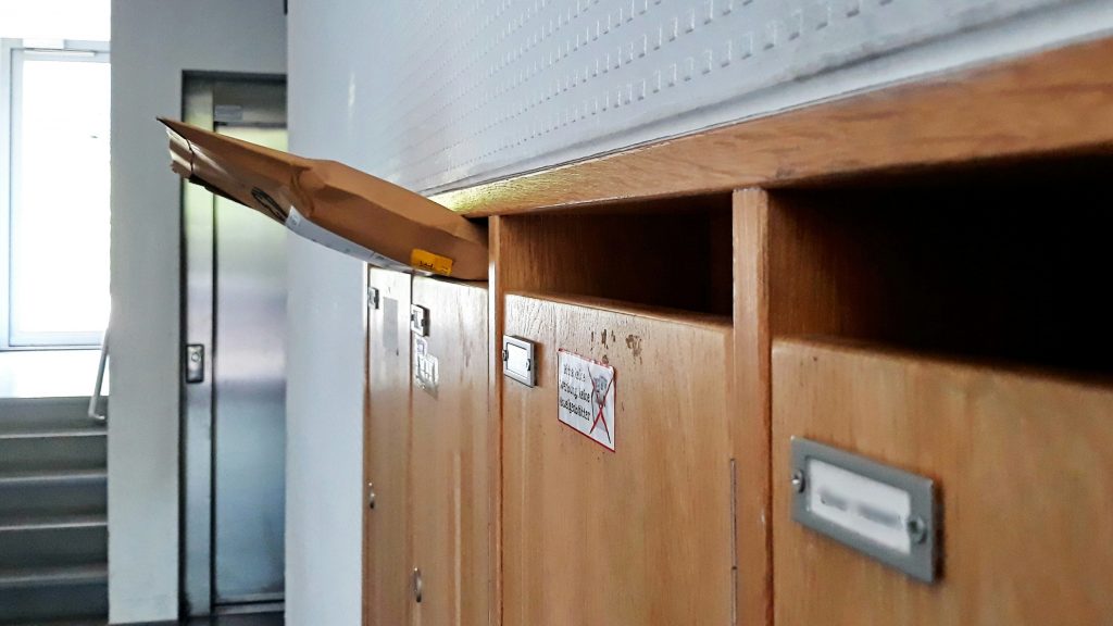 A parcel in a wooden post box to show e-commerce